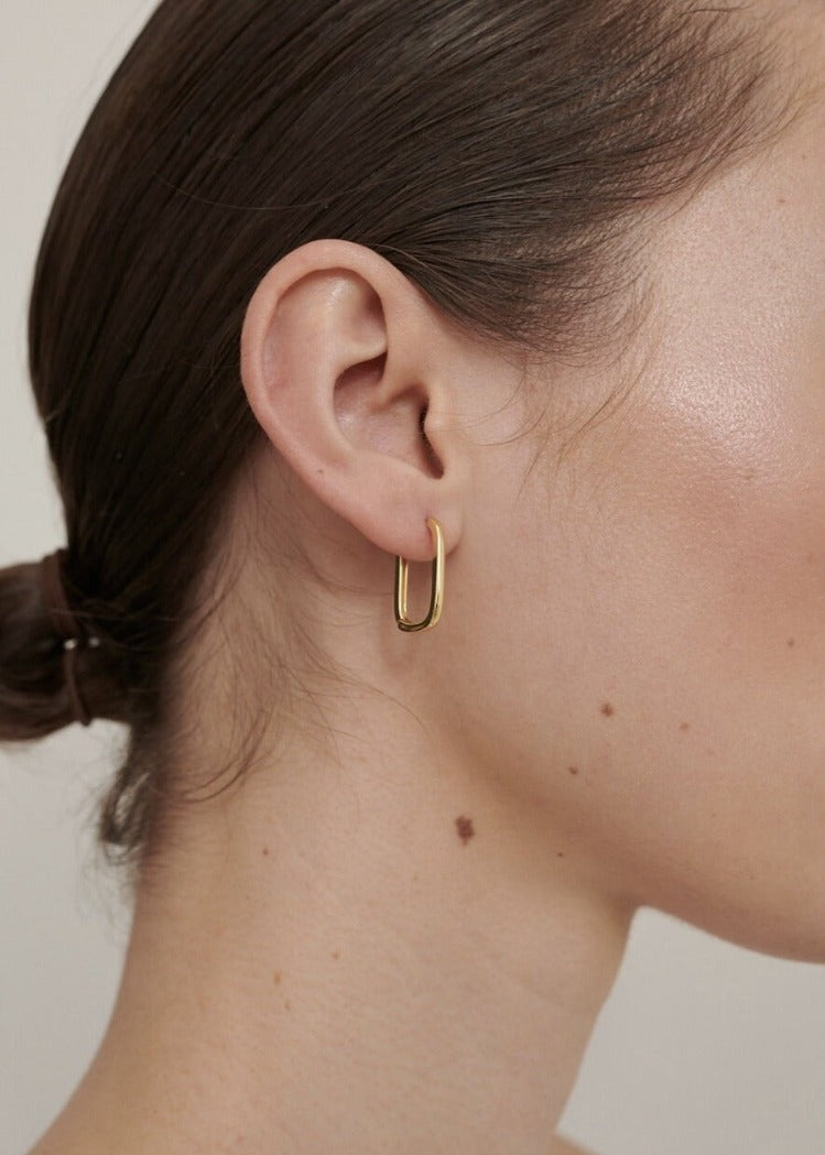 Featured: A Gold Squoval shaped, dainty hoop earring.  (6695455457361)