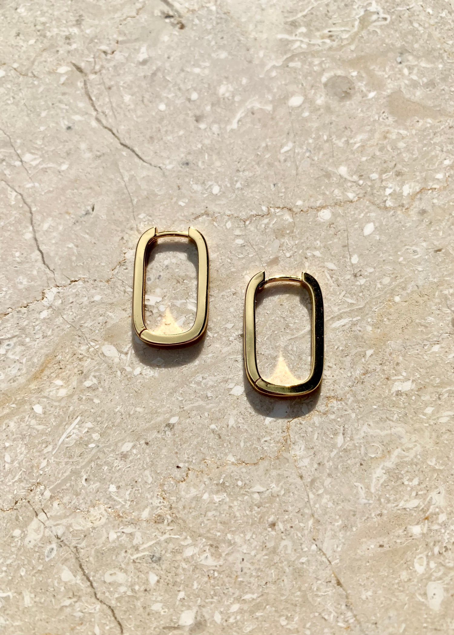 Featured: A Pair of Gold, Squoval shaped, dainty hoop earrings. (6695455457361)